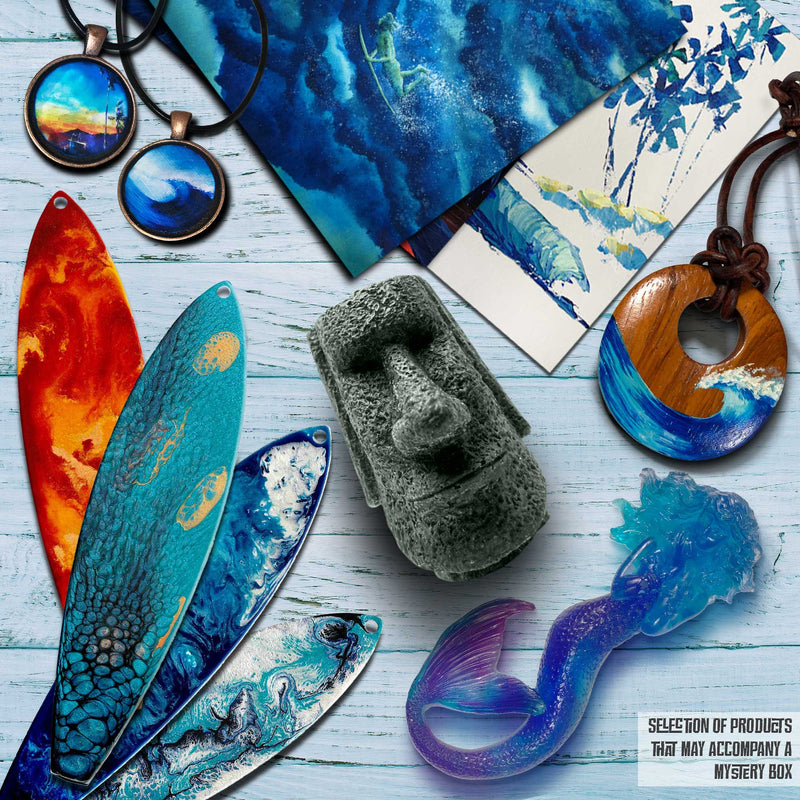 Close-up of mini hand-painted surfboard ornaments, a miniature Moai Tiki Statue, a mermaid ornament, jewelry, and more from the Secrets of the Lost Lagoon Mystery Box, perfect for surf enthusiasts and beach house decor.