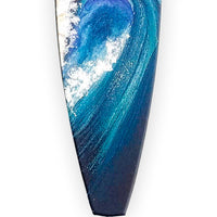 Navy blue Christmas ornament with a hand-painted ocean wave for beach Christmas tree decor.