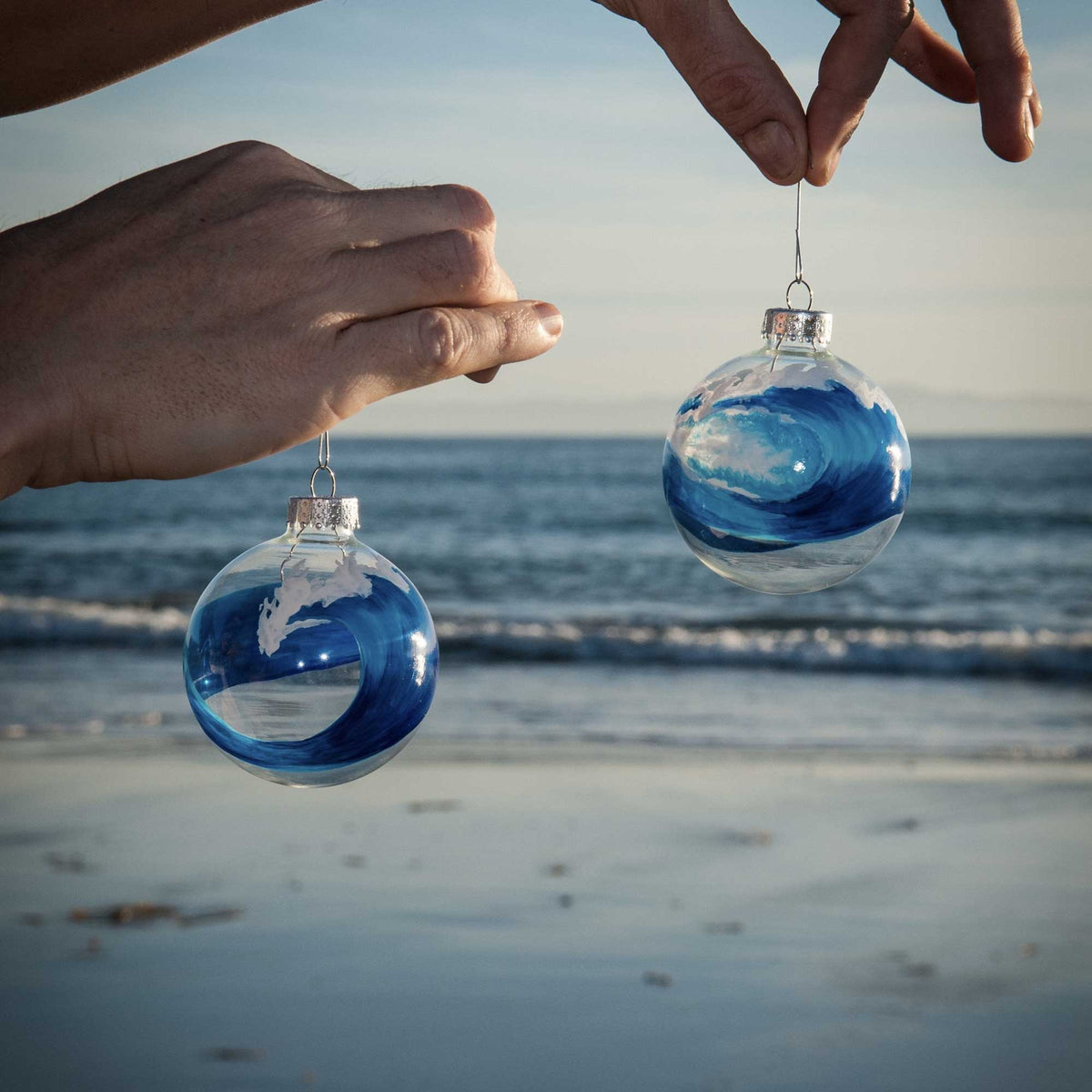 bluewater "swell" and "break" editions being held by a christmas tree hook overlooking the ocean