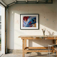 Abstract wave artwork in black frame displayed in sunlit garage studio with workbench and paint brushes