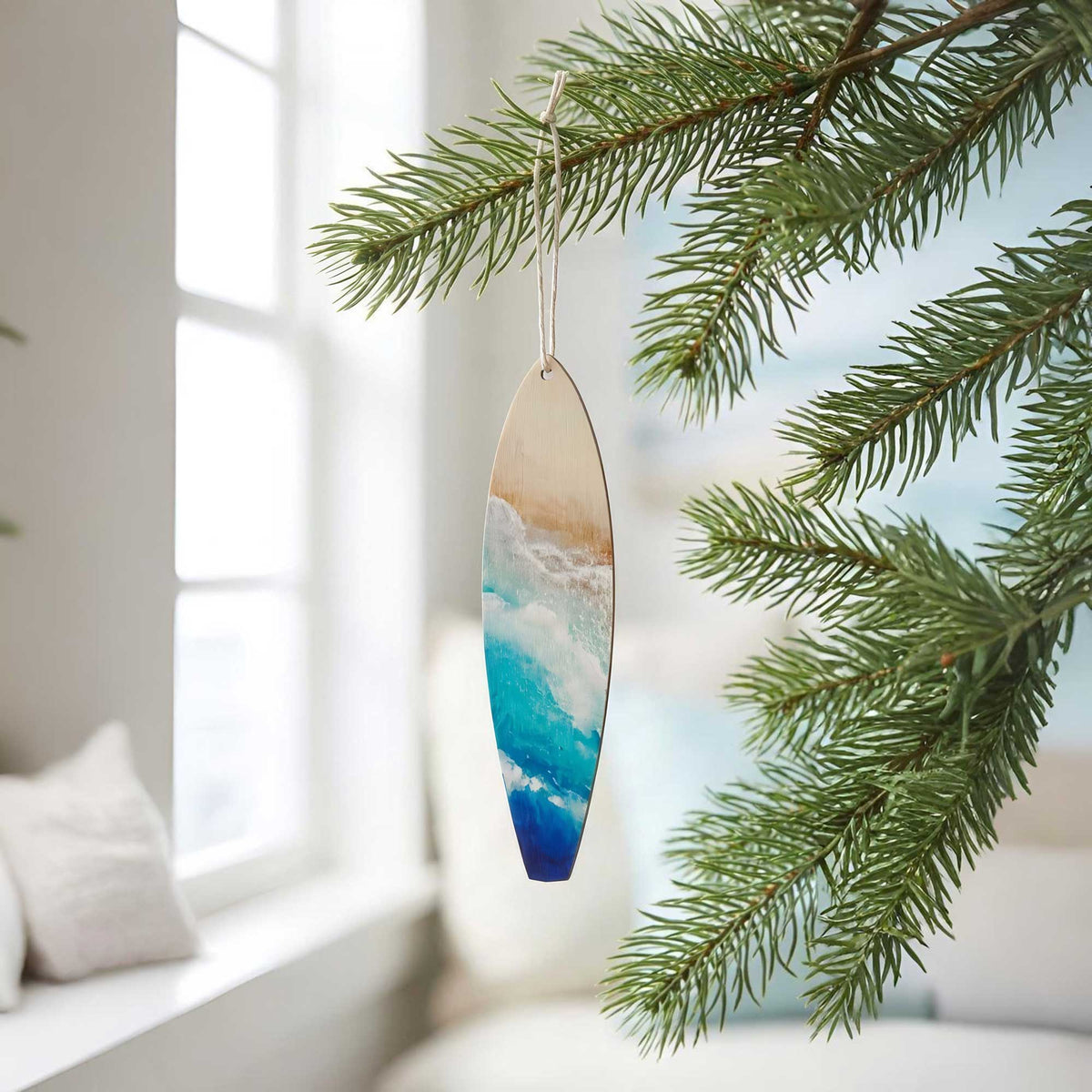 Decorative Castaway surfboard ornament hanging on a holiday tree