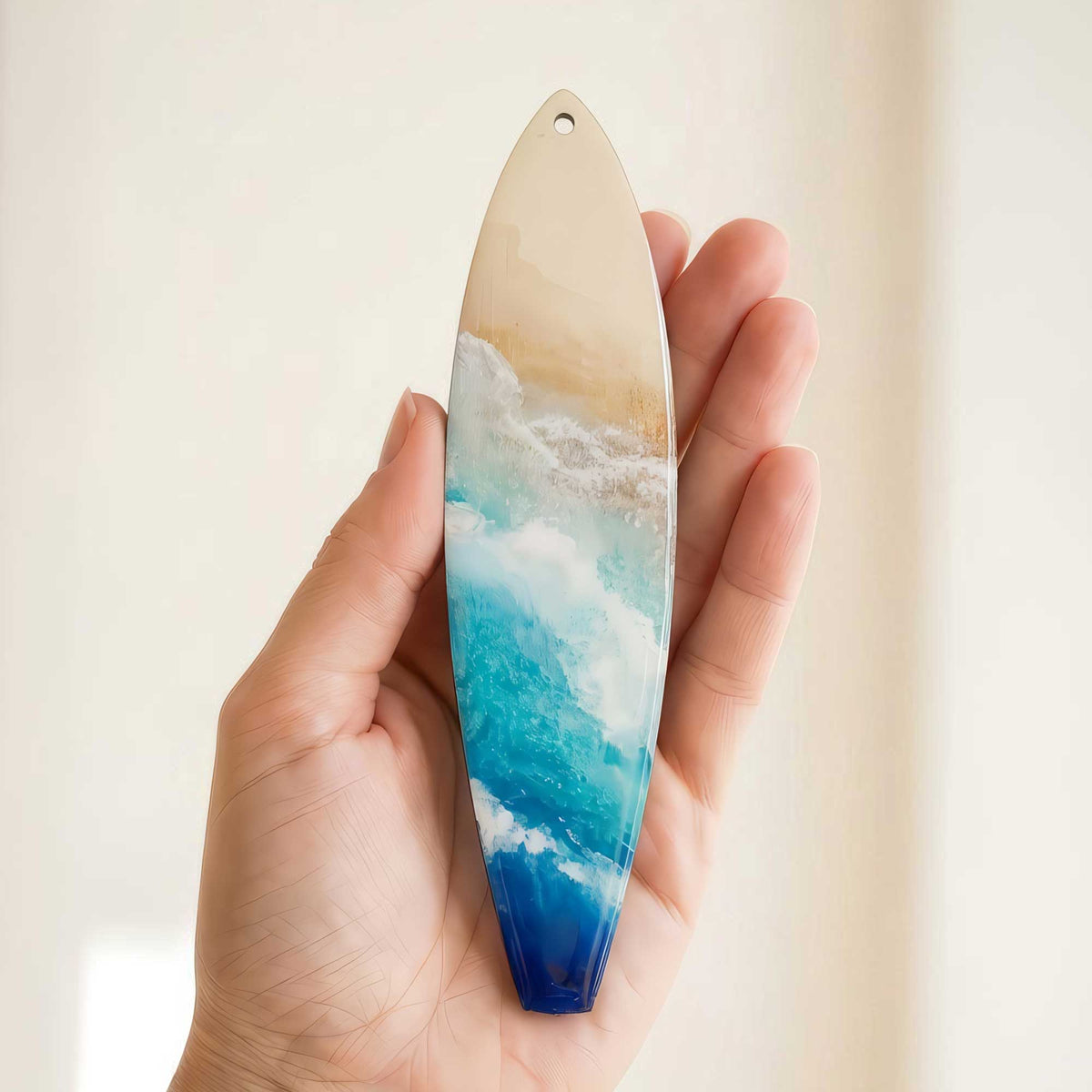 Castaway surfboard holiday ornament shown in hand for size reference