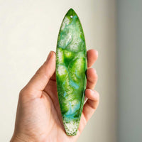 emerald green surfboard holiday ornament shown held in hand for size reference