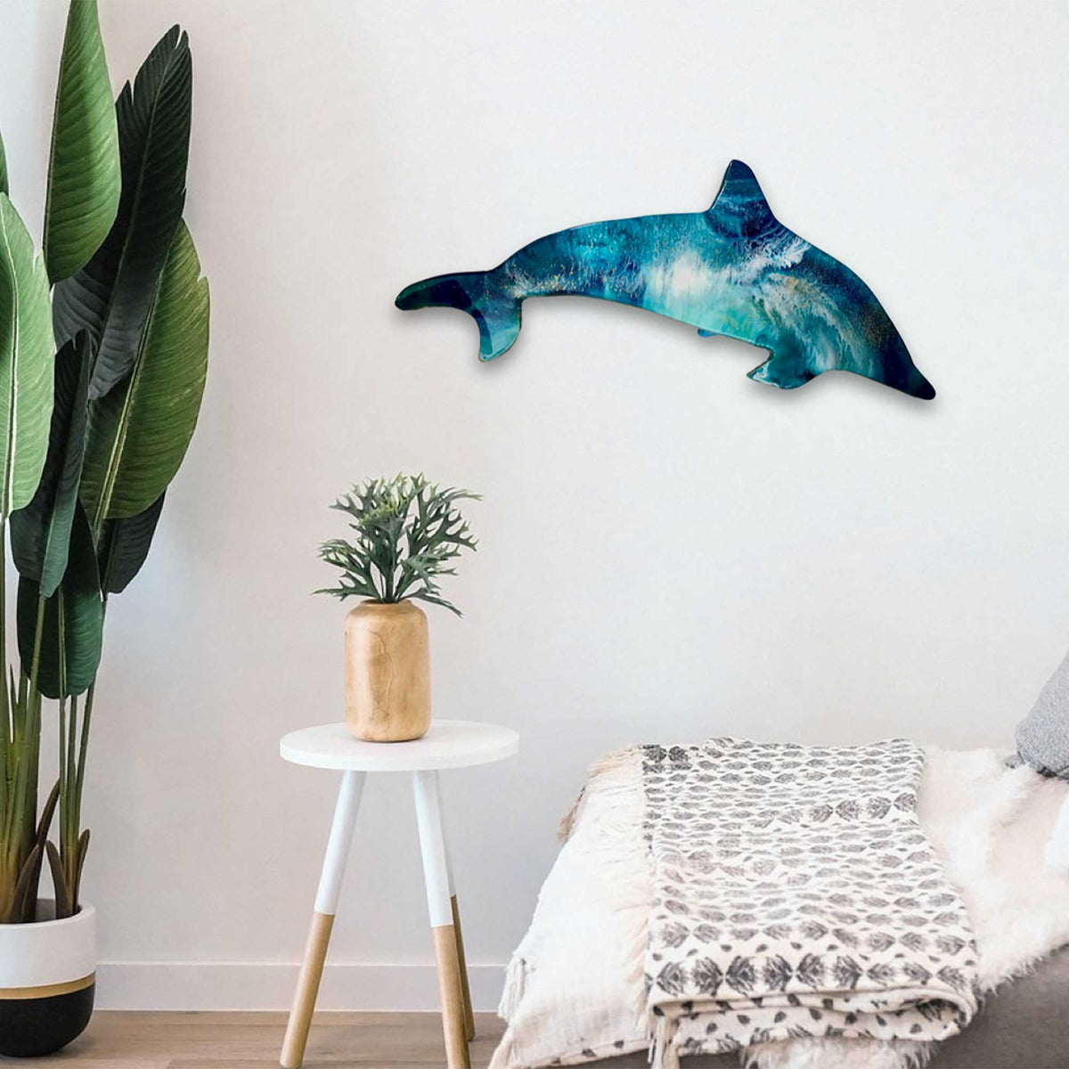 Dolphin resin wall art displayed above a modern coastal living room console