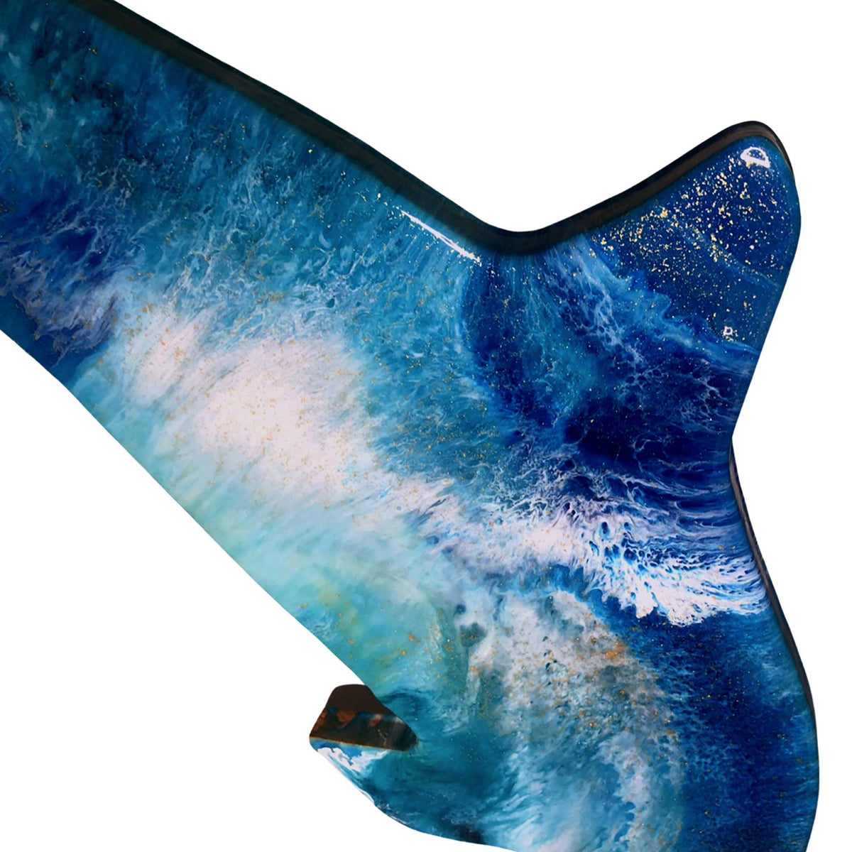 Detail of resin pour showing shimmering gold dust and deep blue ocean swirls