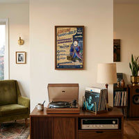 Vault Boy Raithe Kole artwork displayed above a vintage record console in a mid-century listening room.