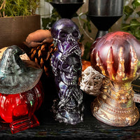 Three Wise Skulls resin figurine displayed with other Halloween decor items shown for styling inspiration