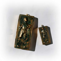 large and small han solo carbonite ornaments side by side on white surface