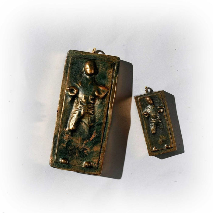 large and small han solo carbonite ornaments side by side on white surface