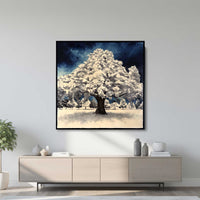 Large framed winter tree oil painting displayed above modern console table in contemporary living room