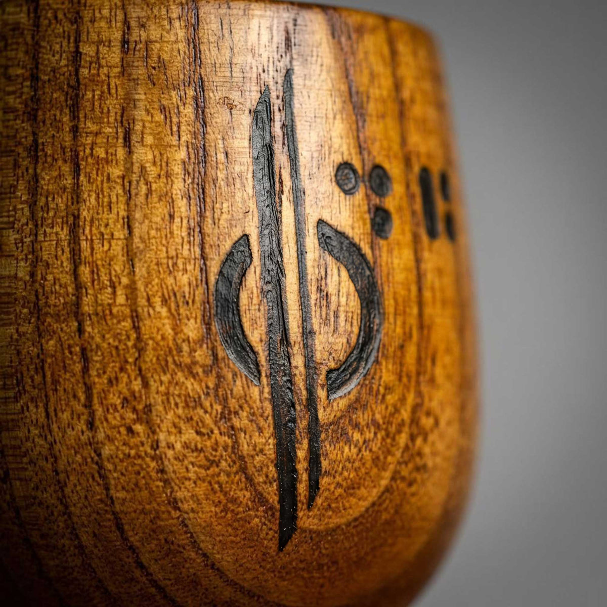Close-up of hand-burned symbol detail on Halcy-Con 2025 Kar’tam wooden cup