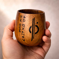 Kar’tam Cup held in hand showing scale, wood grain, and burned markings of the Chandrilla Starlines logo