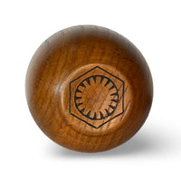 Bottom of wooden Kar’tam cup featuring First Order faction symbol burned into wood