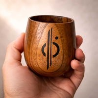 Hand-turned wooden Kar’tam cup held in hand showing size and natural wood grain