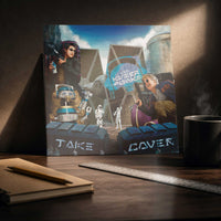 Kyberpunks Take Cover album art print on desk in moody artist workspace with sketchbook coffee and directional light