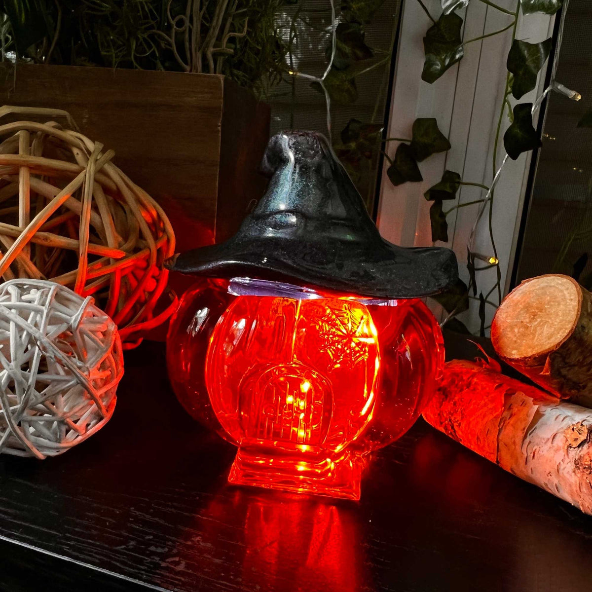 Pumpkin jar Halloween decor glowing with fairy lights inside