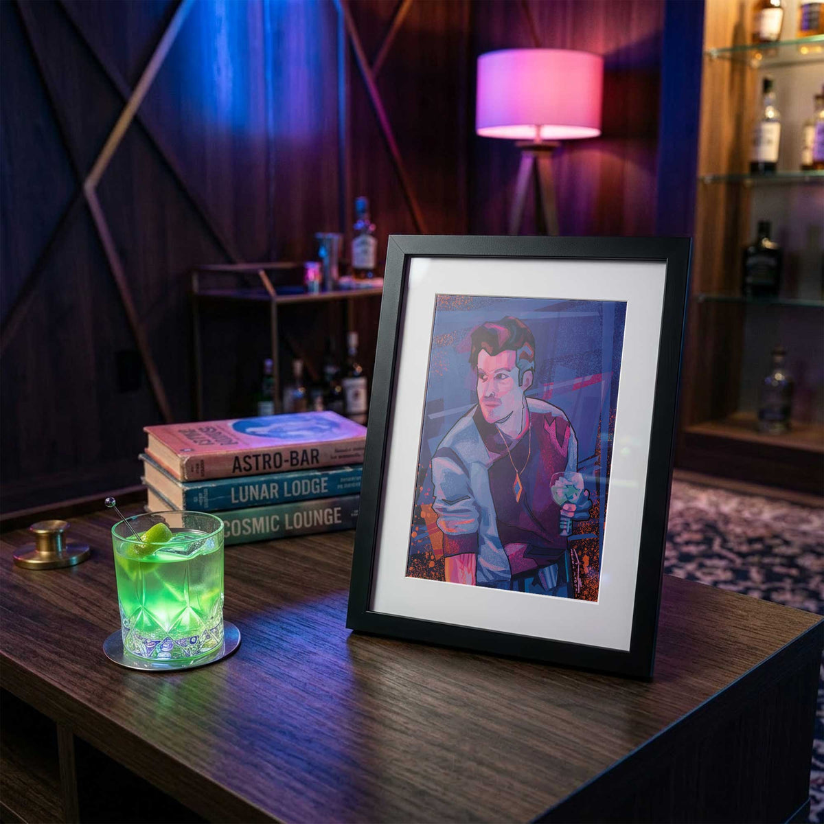 Framed 5x7 Rogue Vibes Starcruiser inspired art print displayed beside a glowing green cocktail in a retro futuristic lounge setting with sci fi books and moody neon lighting.