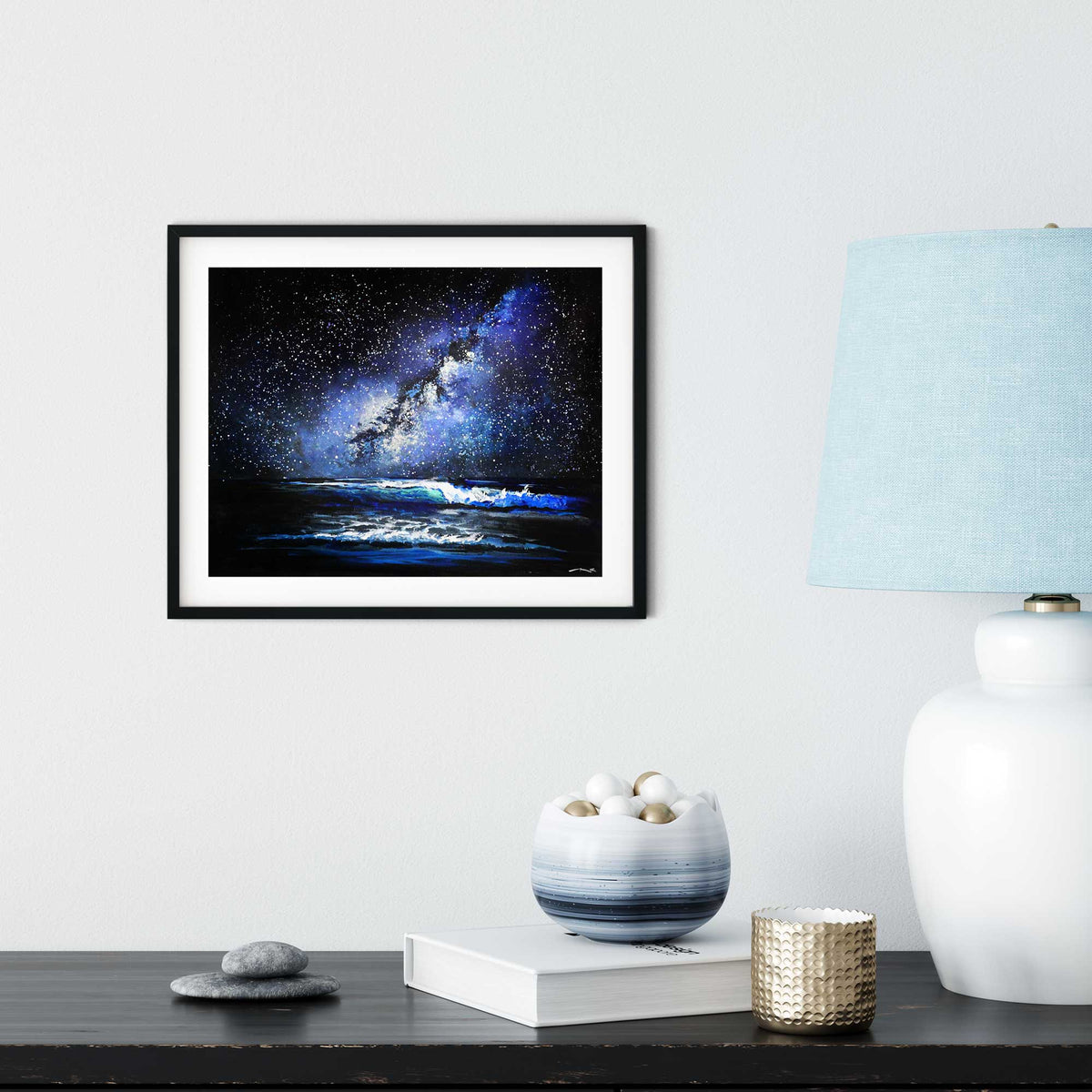 Framed starry night ocean painting displayed in modern minimalist interior with soft coastal styling