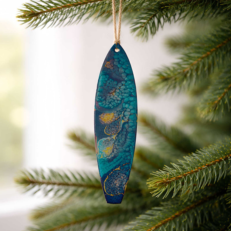 starry night surfboard ornament hanging on a christmas tree branch