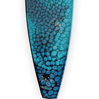 close up of blue resin texture on surfboard holiday ornament