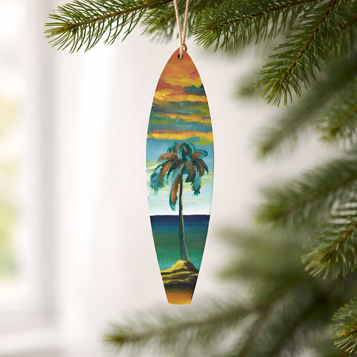 One-of-a-kind Hawaiian Holiday surfboard ornament hanging from a Christmas tree with hand-painted acrylic artwork inspired by island landscapes