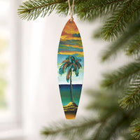 One-of-a-kind Hawaiian Holiday surfboard ornament hanging from a Christmas tree with hand-painted acrylic artwork inspired by island landscapes