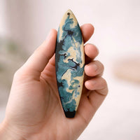 by the sea surfboard ornament held in hand showing small 6 inch size