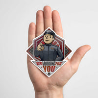Hand holding the We’re Looking for You Lt. Croy sticker to show scale