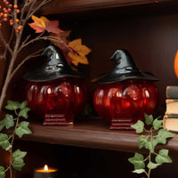 Witch hat pumpkin jar styled in cozy Halloween decor scene