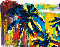 Original beach art of black palm trees silhouetted against a red, blue, green, and yellow sky