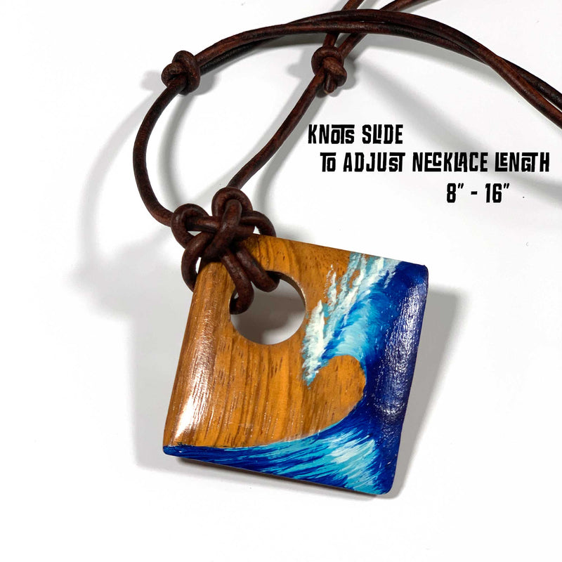 Diamond Head wood pendant necklace with a hand painted blue wave and adjustable length leather cord