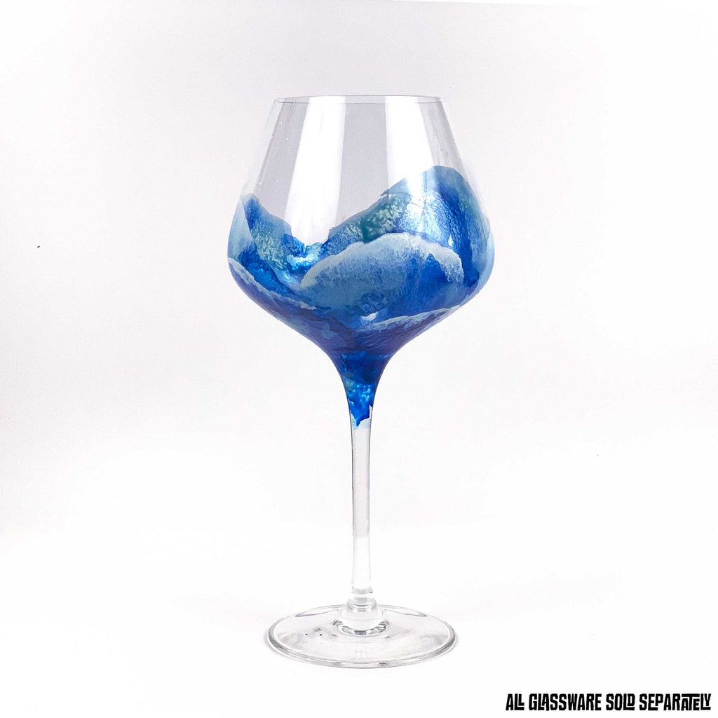 Elegant blue ocean wave glassware. Hand-painted red wine glass, styled as best home bar decor by 5th & Rugged.