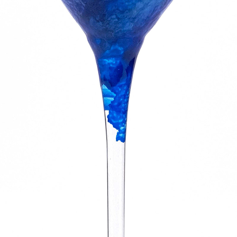 Close view of a custom martini glass showing the beautiful broken blue paint edge along the bottom of the bowl.