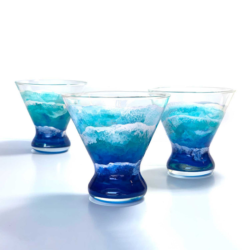 Trio of beautiful blue ocean wave glassware. Hand-painted stemless martini glasses, displayed as best home bar decor by 5th & Rugged.