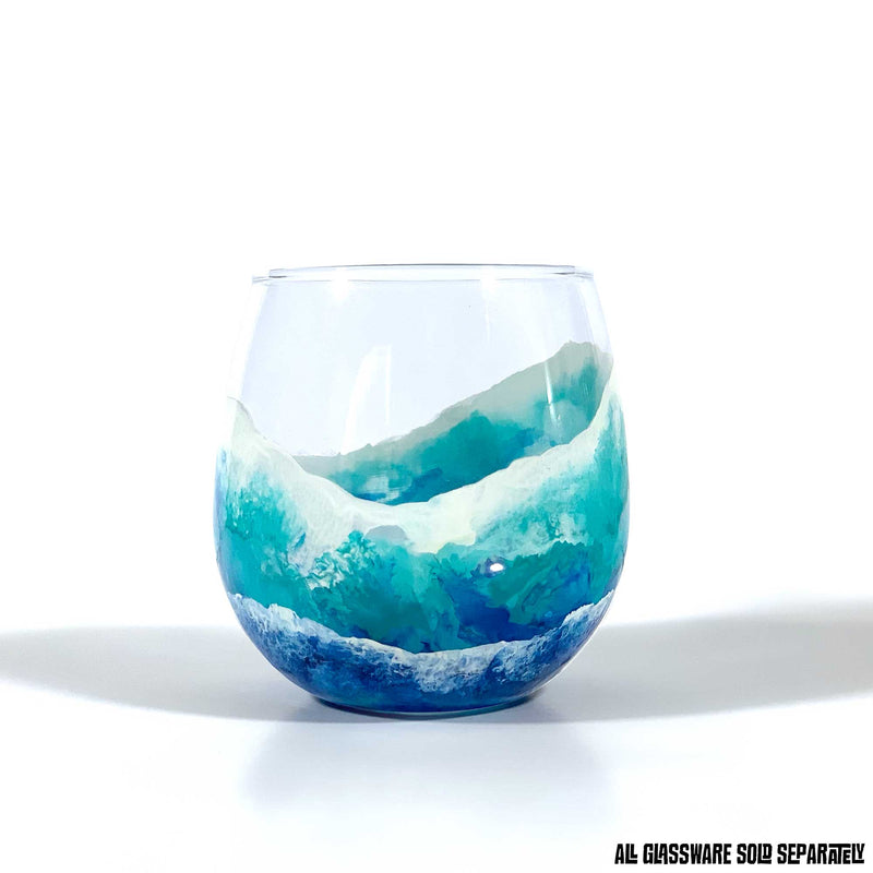 Custom glass for beach themed wedding gift, with blue ocean waves seen from birds-eye-view, wrapping a stemless red wine glass.