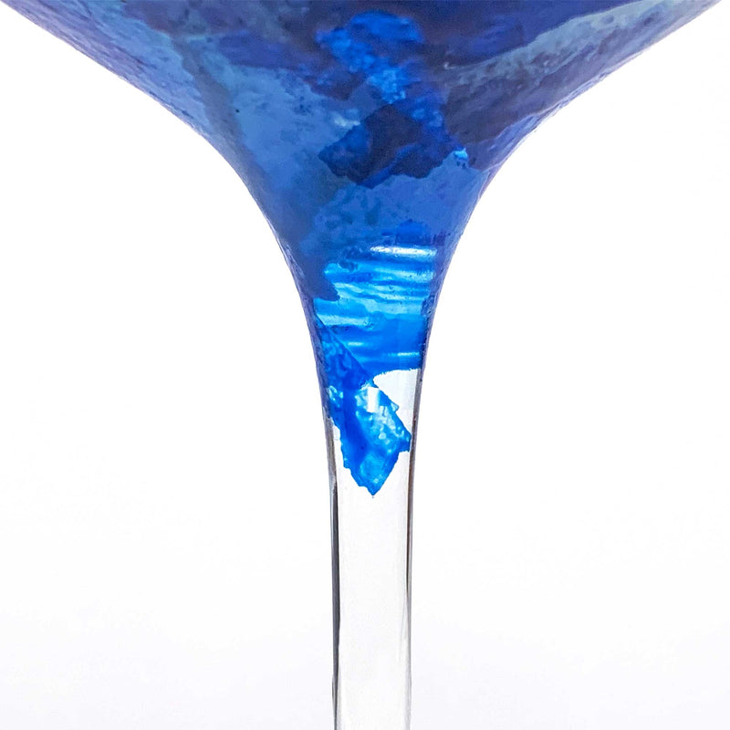 Close view of a custom red wine glass showing the beautiful broken blue paint edge along the bottom of the bowl.