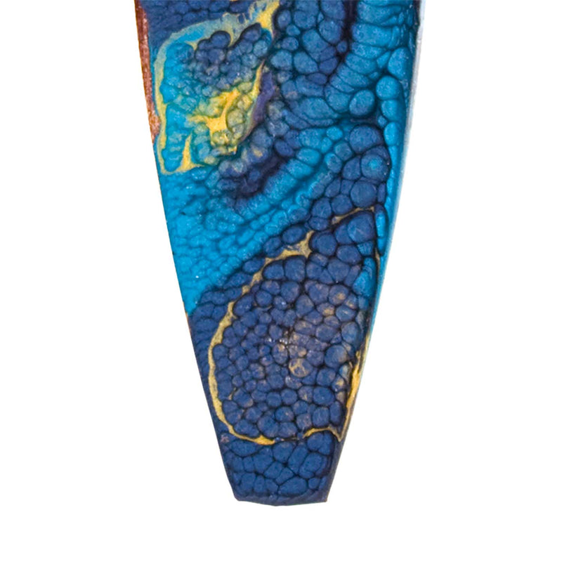 Close view of Starry Night inspired coastal Christmas tree ornament with swirling blue and gold skies and stars.
