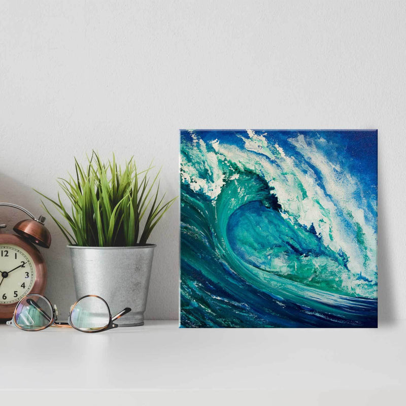 Square printed tile with turquoise painted wave leaning against white wall with minimalist décor