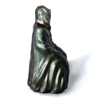 A Grim Reaper statue facing to the right on a white background.  The Reaper's robes are painted with color shifting paint and dry brushed with a metallic gold paint.