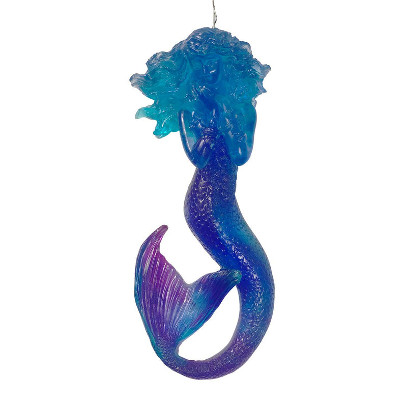Blue mermaid beachy holiday ornament with purple in tail and turquoise accents. Made of translucent resin.