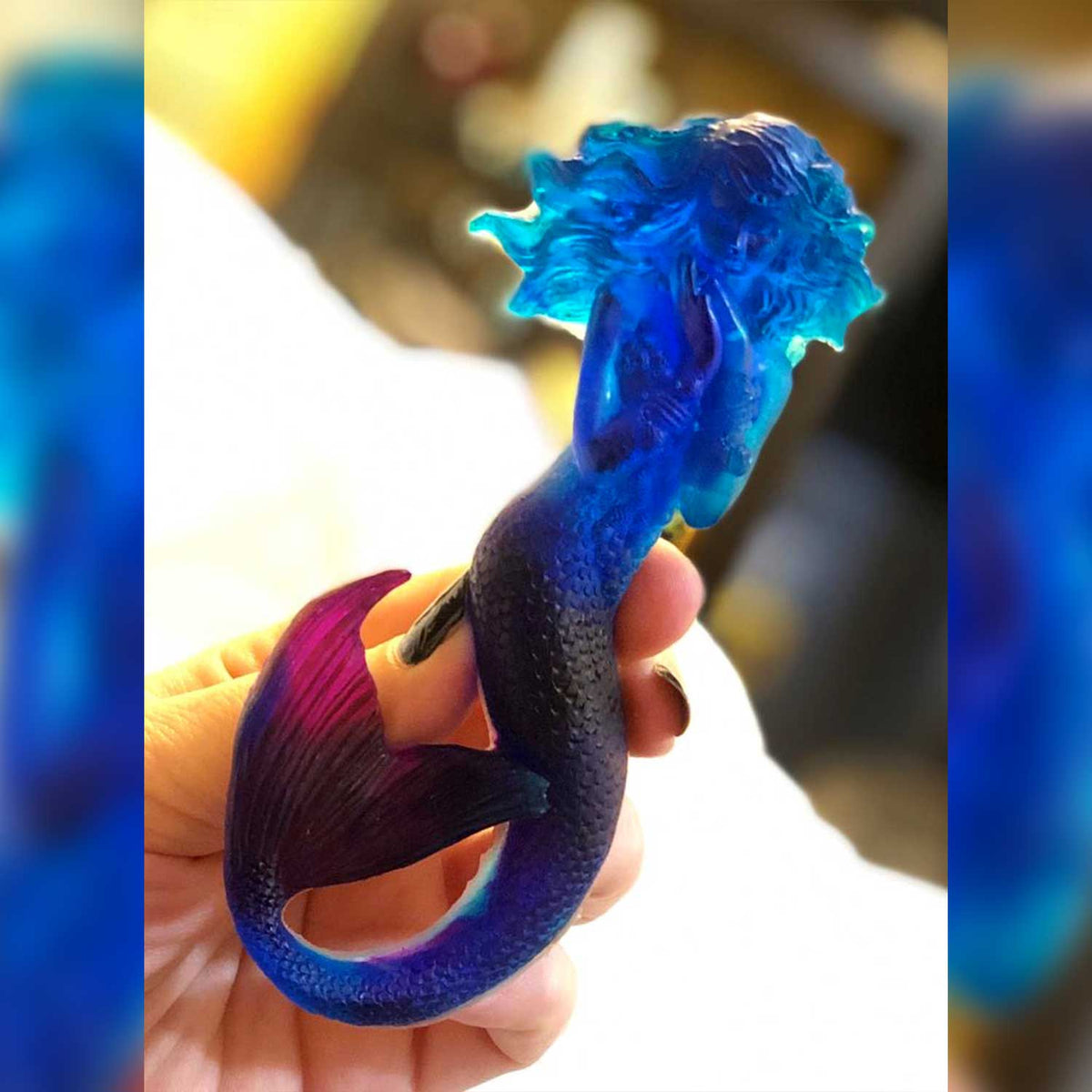 Translucent blue mermaid holiday ornament with purple accents for coastal Christmas tree