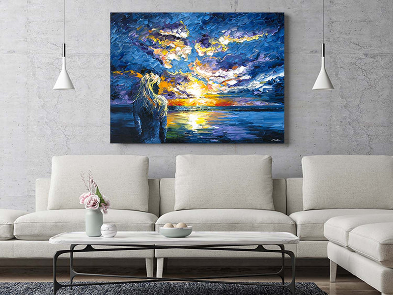 Extra large wall art of a blue and pastel sunset over the ocean in a trendy beach house