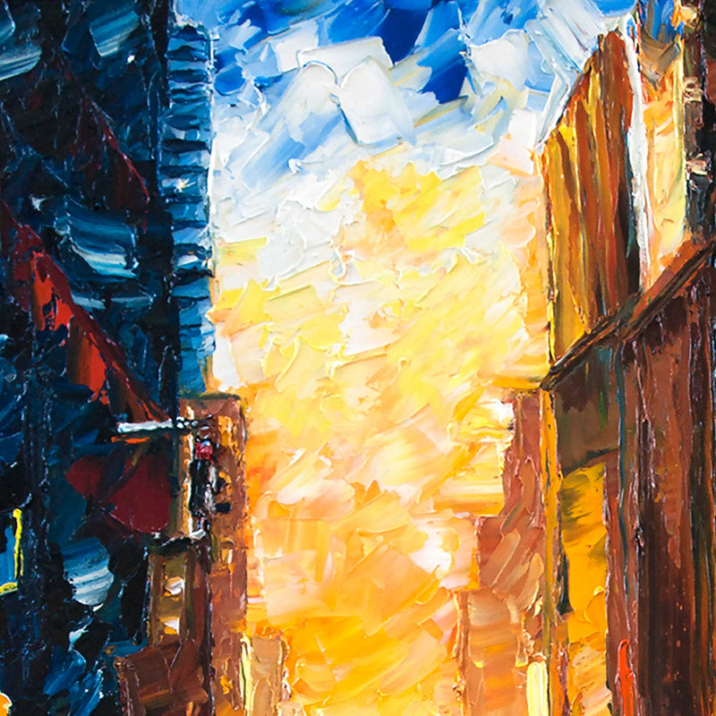 Up close view of an oil painting of a city at sunset painted with thick paint and palette knives