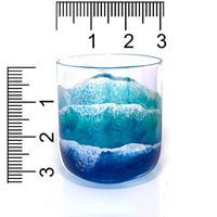 Clear glass tumbler beach wedding gift with painted waves wrapping the glass, shown with a ruler for scale.