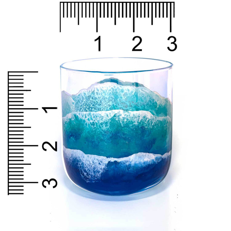 Clear glass tumbler beach wedding gift with painted waves wrapping the glass, shown with a ruler for scale.