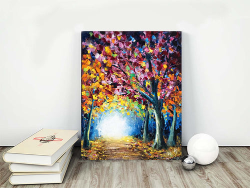 Colorful fall foliage lines a sunny forest path in an original oil painting on canvas. Shown as fall decor for living room.