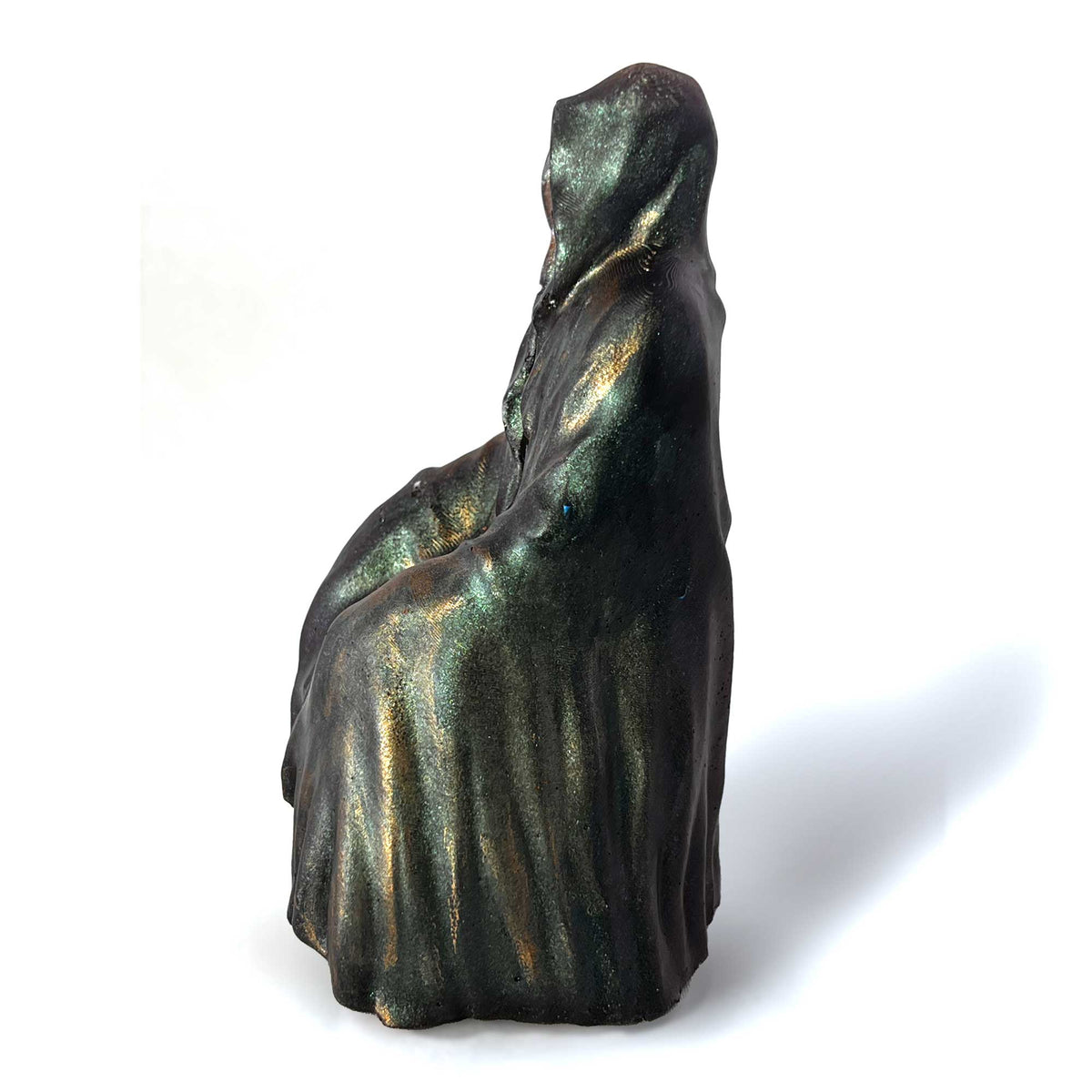 A Grim Reaper figureine facing to the left.  The Reaper's robes are painted with color shifting paint and dry brushed with a metallic gold paint.