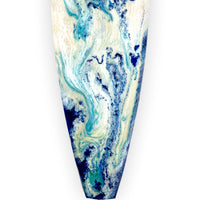 Close up of Christmas beach themed ornaments with blue and white painted on a surfboard holiday ornament.