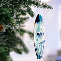 Beach Christmas tree ornament with blue and white ocean swirls painted on a hand-made wood surfboard ornament.