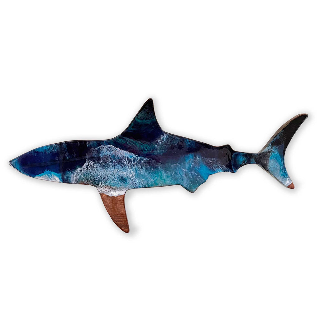 A dark brown stained wooden wall art piece of a shark coated in art resin like ocean waves from above